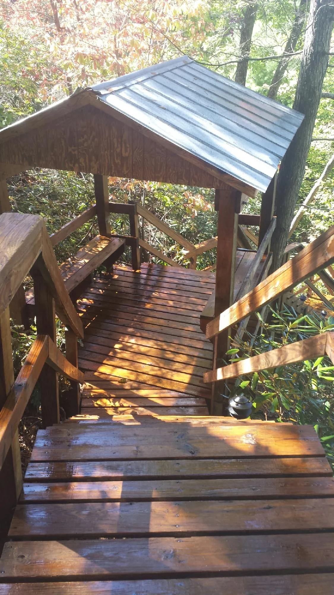 Freshly stained wood walkway and covered shelter with a metal roof in Wessington Springs